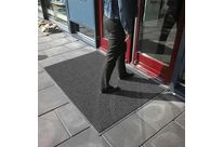 Tapis d'entrée à boucles grattantes et bords biseautés