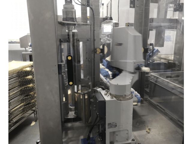 Appareil de pose faux fond pour ligne d’emballage